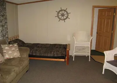 a living room with a couch and a chair at Spacious Vacation Cottage Rental near the Waterfront in Beautiful Put-in-Bay, Ohio in Put-in-Bay