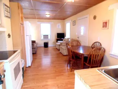 a kitchen and living room with a table and chairs at Enchanting Cottage Rental in Marblehead, Ohio in Marblehead