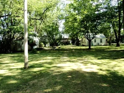 a yard with trees and a pole in the grass at Enchanting Cottage Rental in Marblehead, Ohio in Marblehead