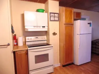 a kitchen with a white stove and a refrigerator at Enchanting Cottage Rental in Marblehead, Ohio in Marblehead