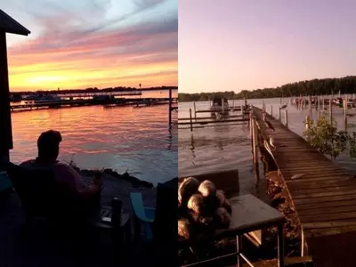 a man and a dog sitting on a table next to a dock at Secluded Cottage Rental in the Trees by Lake Erie, Ohio in Marblehead