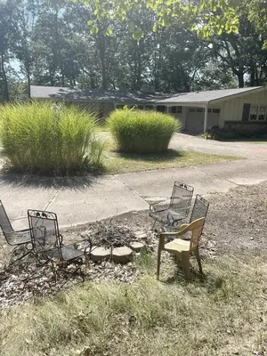 three chairs and a table in a yard at Peaceful Cabin Getaway Overlooking Tuscarawas River Valley in New Philadelphia, Ohio in New Philadelphia