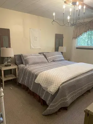 a bedroom with a large bed and two lamps at Peaceful Cabin Getaway Overlooking Tuscarawas River Valley in New Philadelphia, Ohio in New Philadelphia