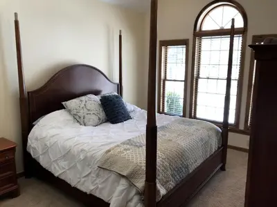 a bedroom with a four poster bed with pillows on it at Enchanting Vacation Rental with a Private Fishing Stream in Sandusky, Ohio in Sandusky