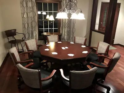 a dining room with a wooden table and chairs at Enchanting Vacation Rental with a Private Fishing Stream in Sandusky, Ohio in Sandusky