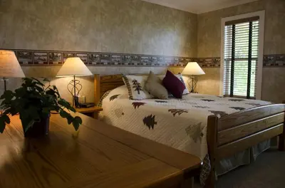 a bedroom with a bed and two lamps and a table at Inviting Suite Rental in a Charming Farmhouse in Sandusky, Ohio in Sandusky