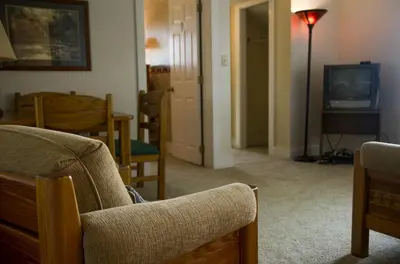 a living room with a couch and a television at Inviting Suite Rental in a Charming Farmhouse in Sandusky, Ohio in Sandusky