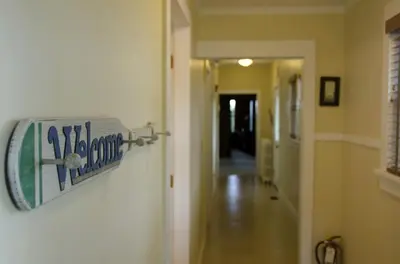 a sign is hanging on a wall in a hallway at Tranquil Weekend Getaway for a Large Group near the Cuyahoga Valley National Park, Ohio in Sandusky