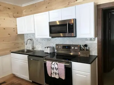 a kitchen with a stove and a microwave at Secluded 1800's Farmhouse Rental Minutes from Cedar Point, Ohio in Sandusky