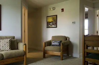 a living room with a chair and a chair at Secluded 1800's Farmhouse Rental Minutes from Cedar Point, Ohio in Sandusky