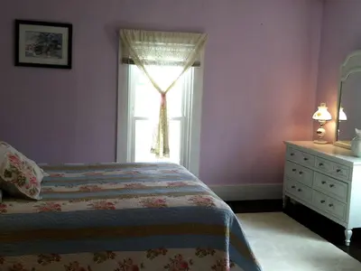 a bedroom with a bed and a window and a dresser at 1800s Farmhouse Cottage Rental on a 230 Acre Farm in Muskingum County, Ohio in Frazeysburg