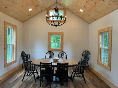 a dining room with a table and chairs at 1800s Farmhouse Cottage Rental on a 230 Acre Farm in Muskingum County, Ohio in Frazeysburg