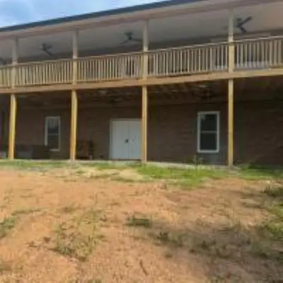 a large house with a balcony on top of it at The Murphy in Sutton