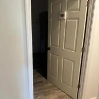 an open white door in a hallway at The Murphy in Sutton
