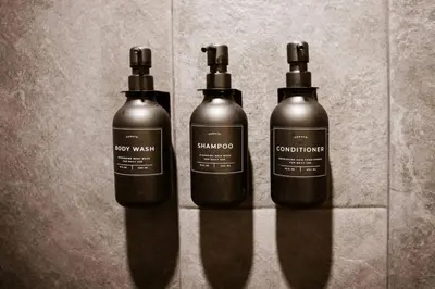 three bottles of shampoo sitting on a wall at The Oak at Middlefork Ridge in Laurelville