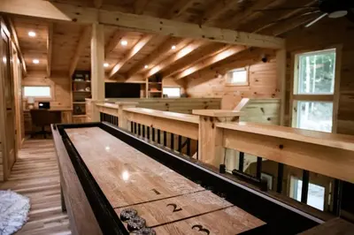 a large wooden room with a table and benches at The Oak at Middlefork Ridge in Laurelville