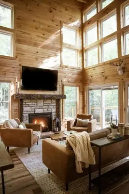 a living room with a fireplace and a tv at The Oak at Middlefork Ridge in Laurelville