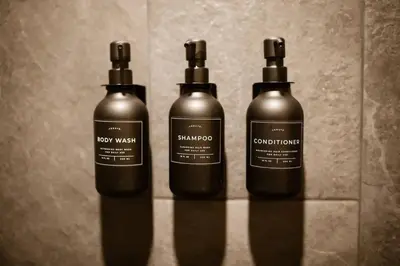 three bottles of shampoo and conditioner on a wall at The Acorn at Middlefork Ridge in Laurelville