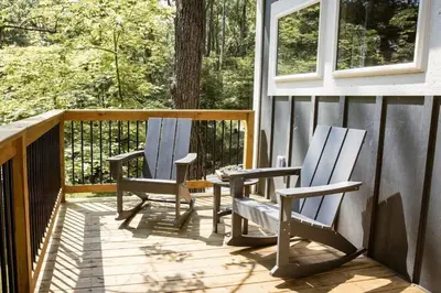 two chairs sitting on the porch of a house at The Acorn at Middlefork Ridge in Laurelville