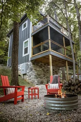 a house with a deck and a fire pit at The Acorn at Middlefork Ridge in Laurelville