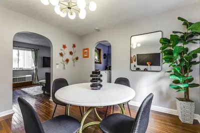 a dining room with a white table and chairs at 1 Mi to University of Cincinnati Avondale Gem! in Cincinnati