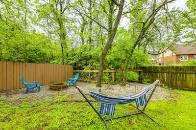 two chairs and a hammock in a yard at 1 Mi to University of Cincinnati Avondale Gem! in Cincinnati