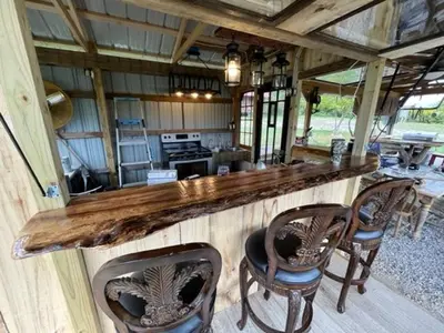 a kitchen with a wooden counter with four chairs at Big Spacious Camper in New Lexington