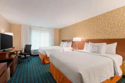 a hotel room with two beds and a flat screen tv at Fairfield Inn & Suites by Marriott Pittsburgh Airport/Robinson Township in Robinson Township