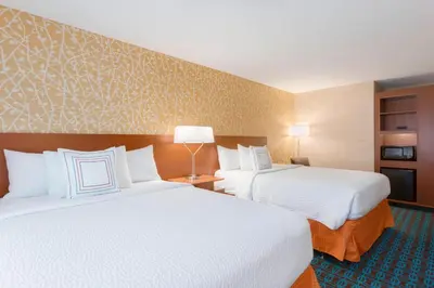 a hotel room with two beds and a lamp at Fairfield Inn & Suites by Marriott Pittsburgh Airport/Robinson Township in Robinson Township