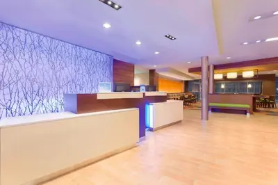 an empty lobby of a hotel with a counter at Fairfield Inn & Suites by Marriott Pittsburgh Airport/Robinson Township in Robinson Township