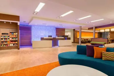 an office lobby with a blue couch and a desk at Fairfield Inn & Suites by Marriott Pittsburgh Airport/Robinson Township in Robinson Township