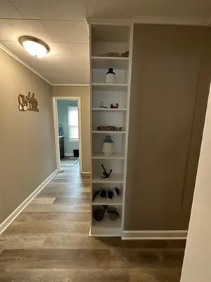 a hallway with a shelf with shoes in it at Off The Hook Vacation Rentals in Put-in-Bay