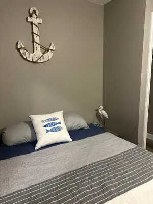 a bedroom with a bed with a anchor on the wall at Off The Hook Vacation Rentals in Put-in-Bay