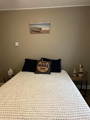 a bedroom with a bed with a pillow on it at Off The Hook Vacation Rentals in Put-in-Bay