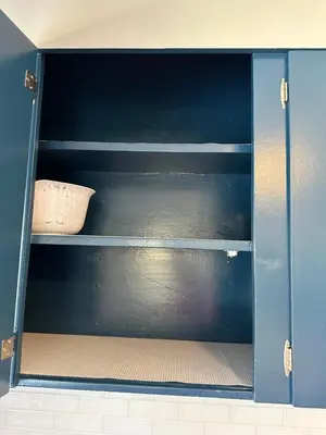 an empty shelf in a cabinet with a bowl on it at Off The Hook Vacation Rentals in Put-in-Bay