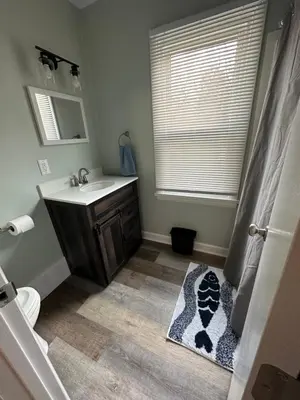 a bathroom with a sink and a toilet and a shower at Off The Hook Vacation Rentals in Put-in-Bay