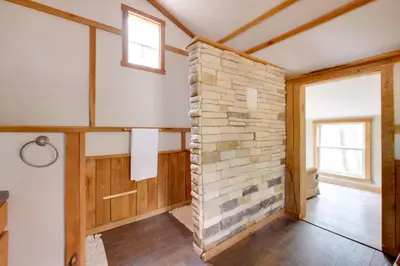 a room with a stone wall in a house at Cabin with Trail Access to Mohican River in Brinkhaven