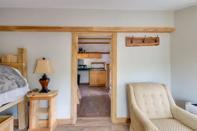a bedroom with a bed and a desk and a chair at Cabin with Trail Access to Mohican River in Brinkhaven