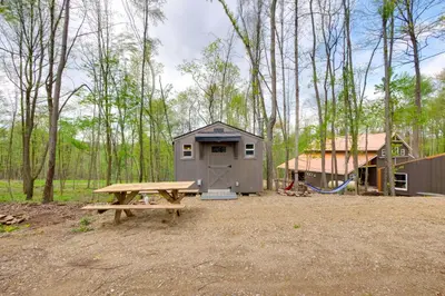 a picnic table and a shed in the woods at On-Site Trails to Mohican River Tiny Home Retreat in Brinkhaven