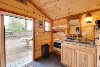 a kitchen with a sink and a stove in a cabin at On-Site Trails to Mohican River Tiny Home Retreat in Brinkhaven