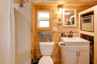 a small bathroom with a toilet and a sink at 1 Mi to Mohican River Wooded Retreat with Trails! in Brinkhaven