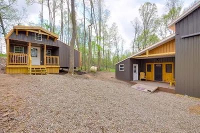 a house with a yard next to a building at 1 Mi to Mohican River Wooded Retreat with Trails! in Brinkhaven