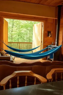 two blue hammocks in a room with a window at Magical Family Tree House in Secluded Woodland near Germantown, Kentucky in Germantown