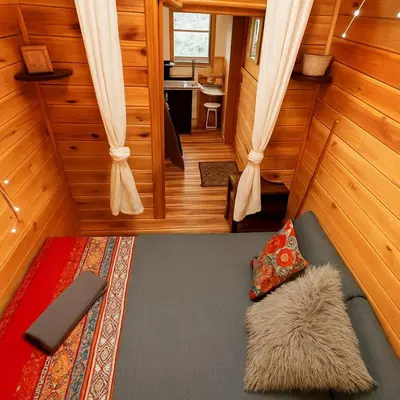a small room with a bed in a small room at Enchanting Tree House with a Slide on 200 Acres for a Family Adventure in Germantown, Kentucky in Germantown
