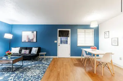 a blue living room with a couch and a table at OSU - Heart of Short North -STEPS from High ST-OSU in Columbus