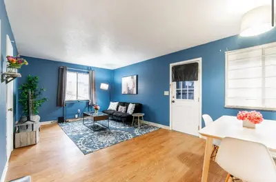 a living room with blue walls and a table at OSU - Heart of Short North -STEPS from High ST-OSU in Columbus
