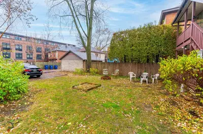 a yard with chairs and a fence and a car at OSU - Heart of Short North -STEPS from High ST-OSU in Columbus