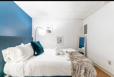 a bedroom with a large white bed with blue walls at OSU - Heart of Short North -STEPS from High ST-OSU in Columbus