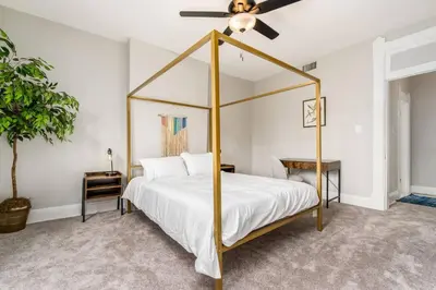 a bedroom with a four poster bed with a ceiling fan at Short north- STEPS to High St -Private Parking-OSU in Columbus