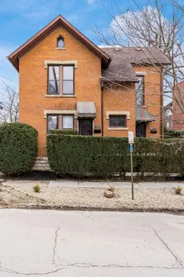 a brick house with a sign in front of it at Short north- STEPS to High St -Private Parking-OSU in Columbus